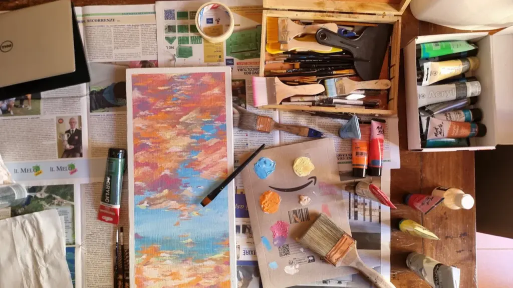 Meniu su įvairiomis meno priemonėmis, dažais ir drobėmis pasiruošus kūrybiniam procesui.